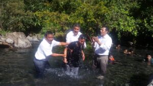 Pastor Hugo baptising. Harvesters Ministries