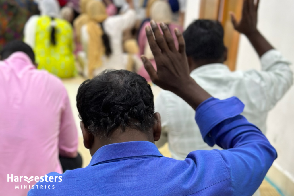 Men hands raised in worship. Harvesters Ministries